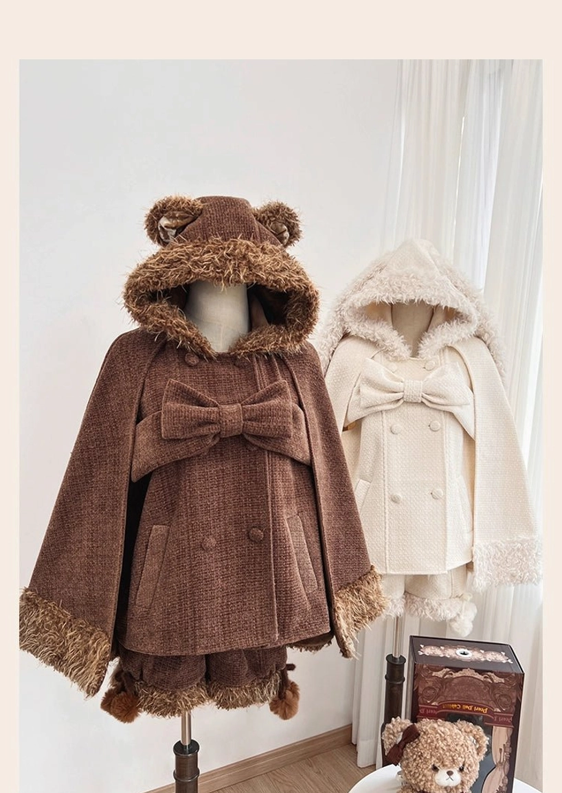 Lolita winter cape with pom-pom shorts ensemble styled with petticoat underneath showing authentic silhouette proportions and layering technique for sweet lolita aesthetic