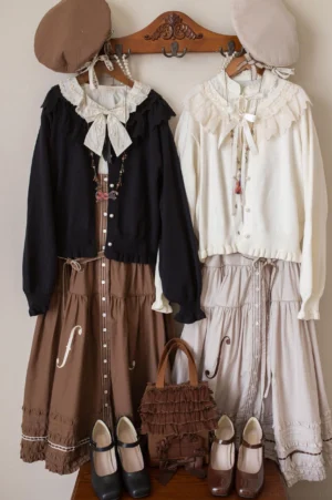 Flat lay overhead display of vintage Peter Pan lolita cardigan collection in multiple colors with coordinating lace skirts, leather shoes and vintage handbag accessory