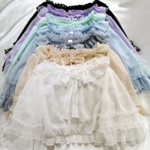 Multiple pastel color options of ruffled lolita chiffon blouses stacked flat lay overhead view white background