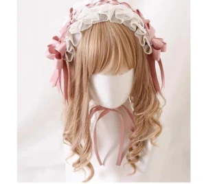 Lolita style choker necklace with dusty pink satin bow, gemstone pendant, and ivory mesh band with adjustable gold clasp shown in top-down flat lay on white background