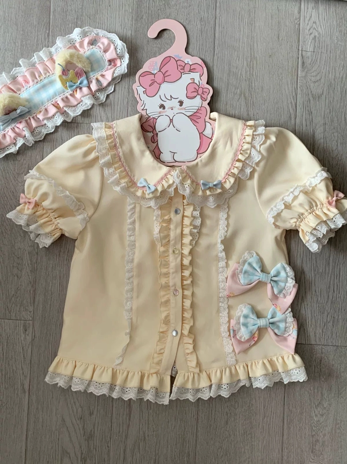 Lolita blouse matching companion short-sleeve peter pan collar ruffled lace blue bow details flat lay