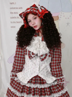 Vintage Lolita coordinate styling with floral blouse and red plaid skirt - model wearing lace-trimmed layered plaid skirt with tiered ruffles, complete Lolita outfit with gingham bonnet and neck ribbon