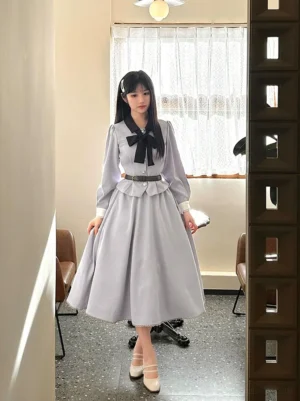 Daily lolita outfit full standing pose showing long-sleeve coat with black bow collar, peplum waist detail skirt with brown belt, mary jane shoes and complete coordinate styling