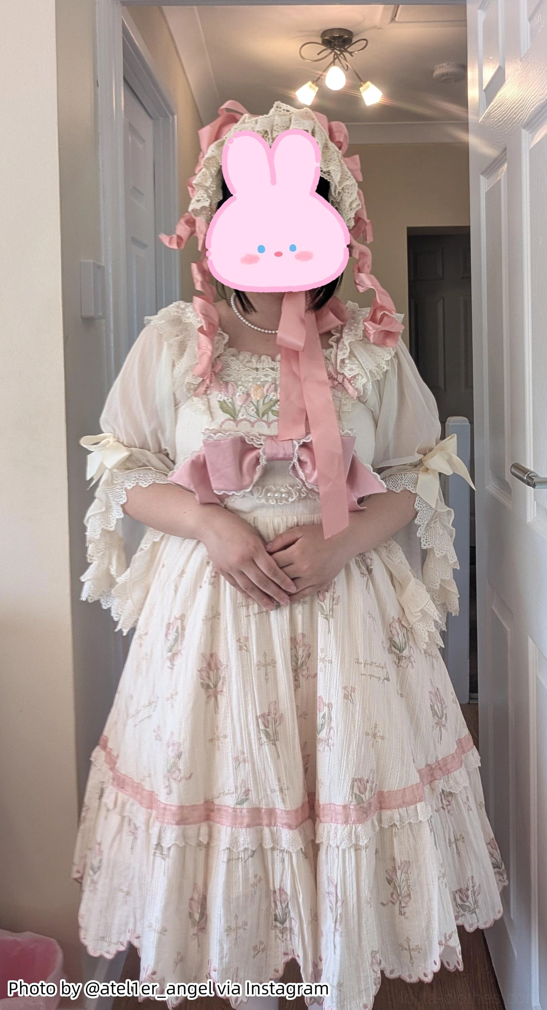 Beige printed lolita daily dress with pink bow accents ruffled hem sleeves matched petticoat front view