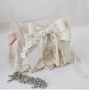 Elegant ivory and pink lolita daisy handbag paired with detachable metal chain strap, front oblique view showing bag structure
