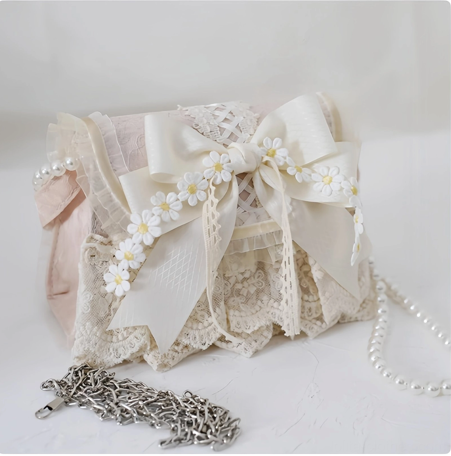 Elegant ivory and pink lolita daisy handbag paired with detachable metal chain strap, front oblique view showing bag structure
