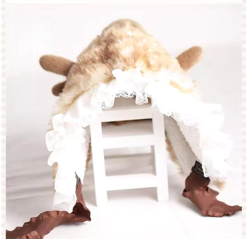 Flat lay display of plush kawaii deer ear lolita winter hat on white wooden stool showing white lace edge, brown tie straps, and one-size-fits-all design