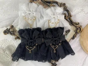 vintage-inspired-double-layer-lace-lolita-wrist-cuffs-black-white-options-pearl-chain-bow-accents-flat-lay-display