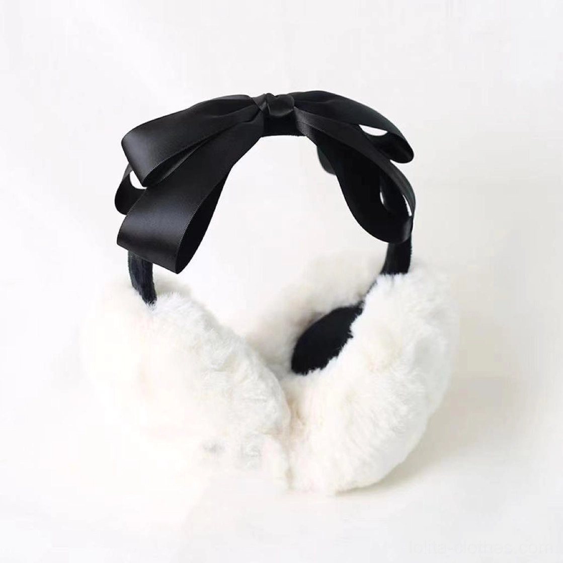 Winter lolita earmuff headdress flat lay product display, all-black satin bow design, white fluffy ear cups with black inner padding, standalone shot