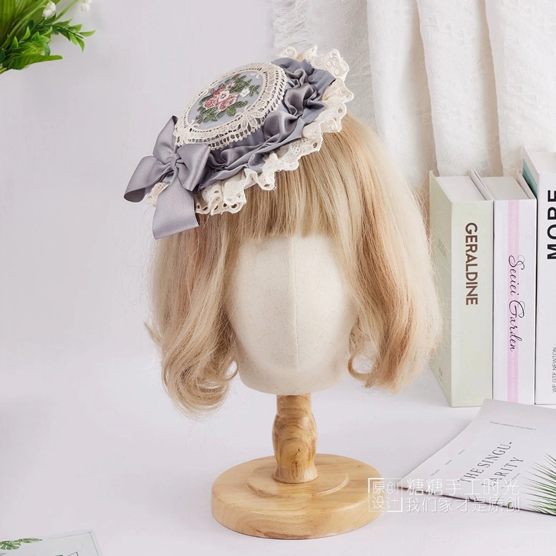 Romantic miniature Lolita top hat featuring dusty lavender satin bow, hand-stitched round floral embroidery, and delicate ruffled white lace border