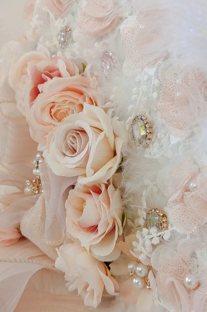 Close-up macro view of Lolita floral decorative set showing artificial peach roses, various rhinestones, pearl beads and silk fabric accents, handcrafted ornament details and embellishments