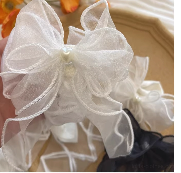 Versatile pair of lolita gauze ankle socks available in black and white with matching pearl-centered organza bows, lattice crisscross straps and heart details for complete coordinate styling