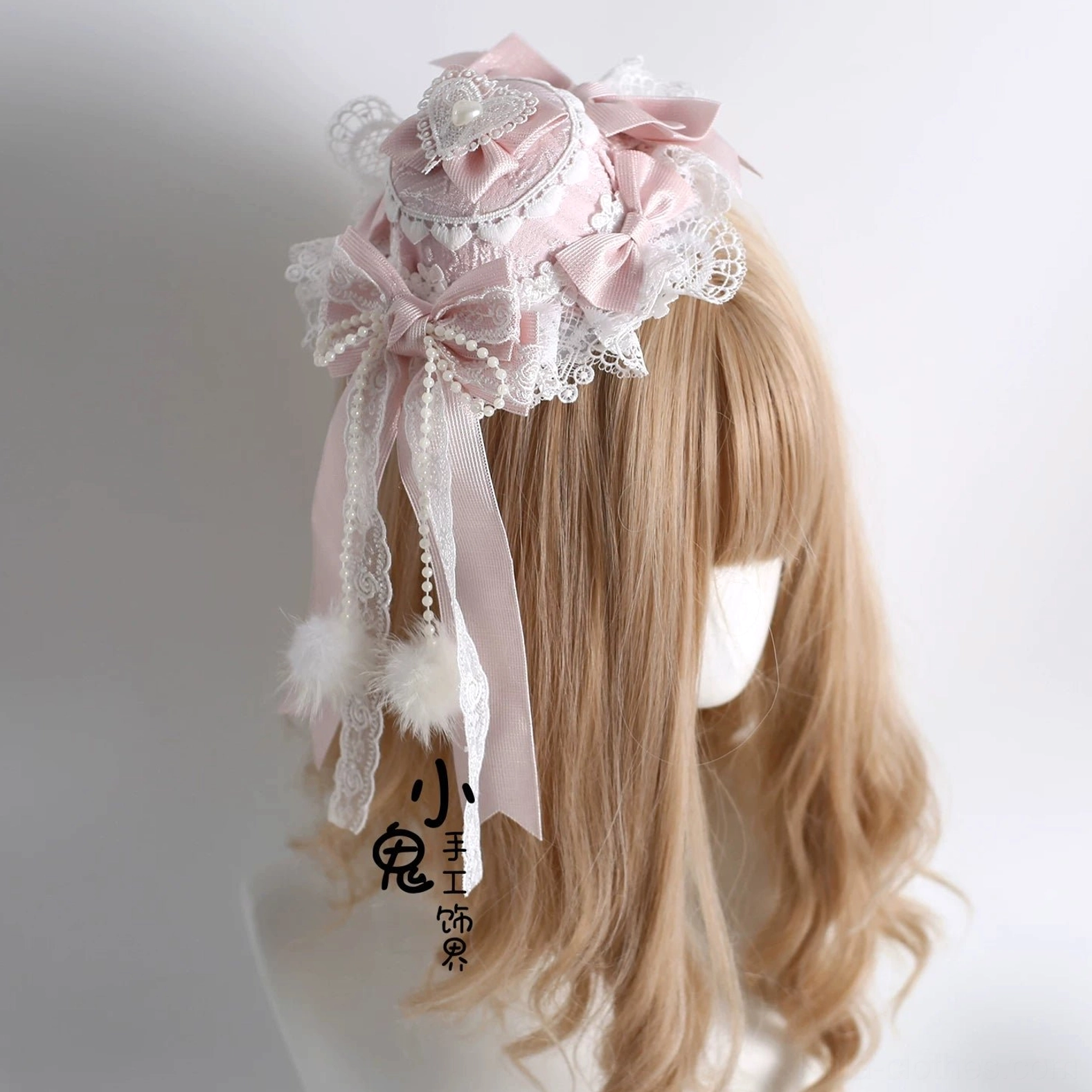 Lolita hair accessory close-up showcasing double-layer lace embroidery, pom-pom embellishments, satin bow construction, and delicate ruffled trim details