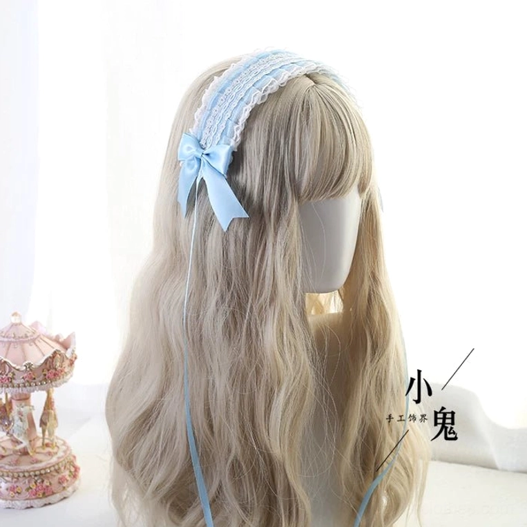 Flat lay overhead view of two lolita headband color options featuring light purple and light gray with satin bows and metal hair clips