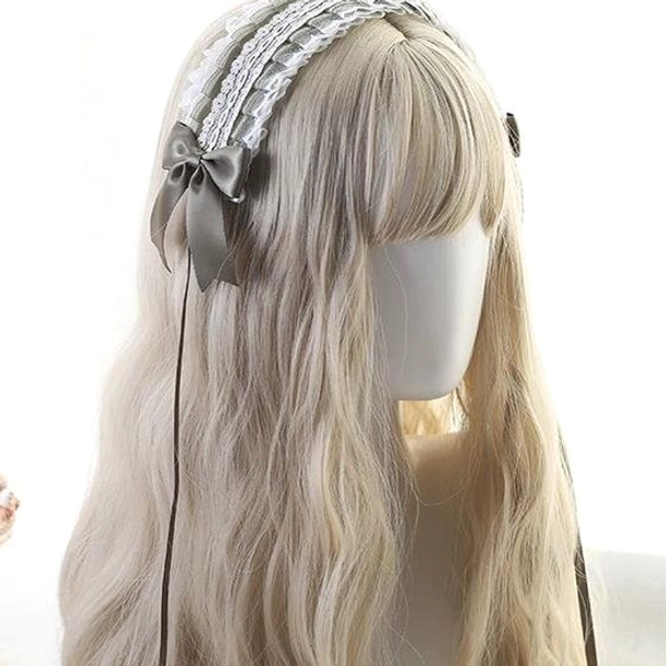 Delicate lolita headdress close-up showing taupe gray satin bow, double-layer white lace edge detail and thin ribbon tail extension