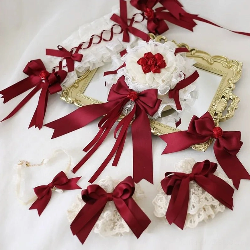 Complete lolita hair and wrist accessory coordination flat lay overhead golden vintage photo frame background showing assorted wine-red satin bows white ruffled lace red flower decorations matching lace wrist ornaments