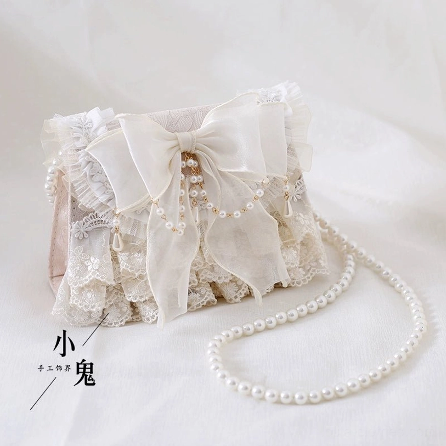 Ivory lolita handbag magnetic closure lock detail with pearl chain pearl tassel bow refined handbag mechanism