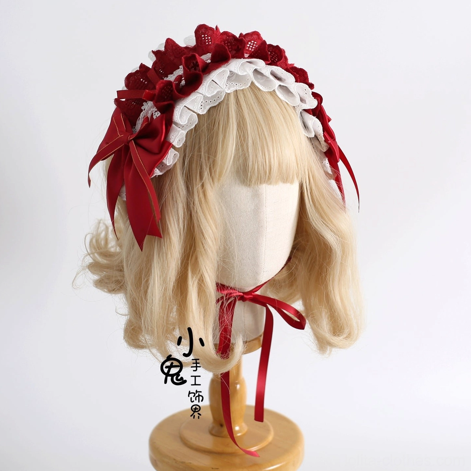 Elegant lolita headband KC featuring red dotted ruffled lace, side satin bows, white scalloped trim, and matching neck accessory on display stand with blonde wig