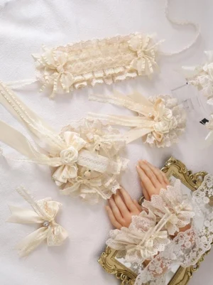 Complete lolita accessory set flat lay including headdress, hair clips, wrist cuffs, headband and bow accessories on white background with decorative mannequin hands