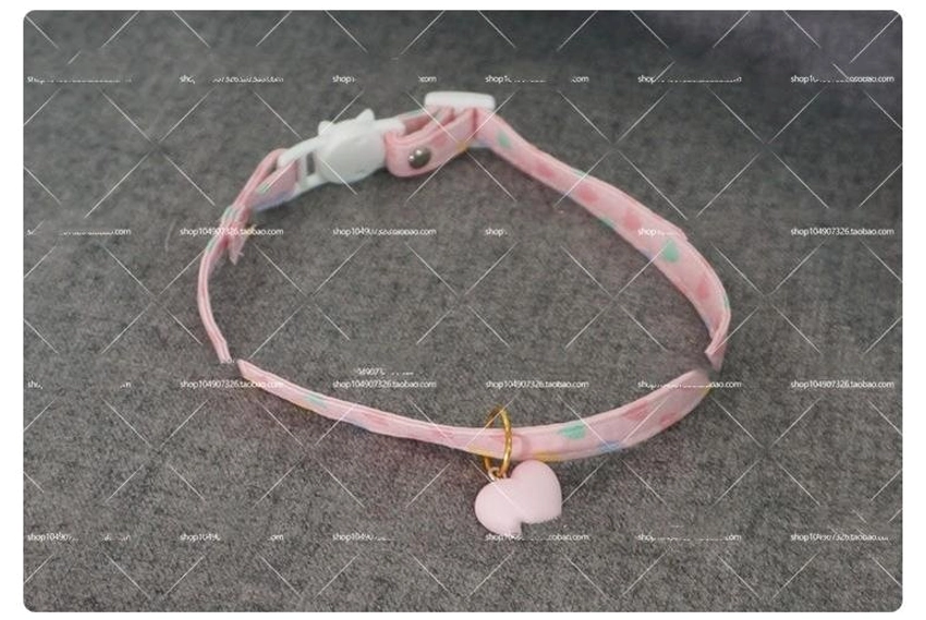Pink heart print choker adjustment mechanism detail showing white cat buckle safety design on grey grid background lolita jewelry