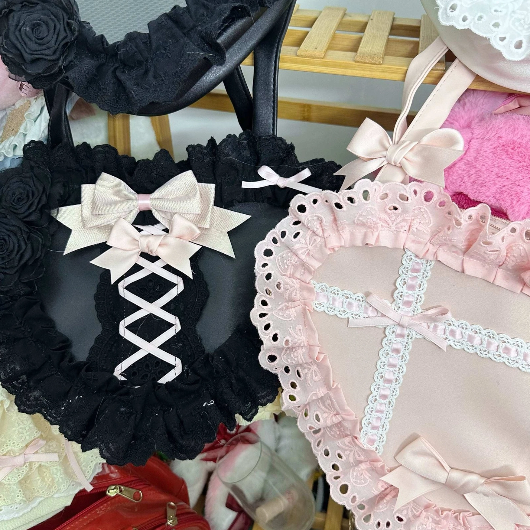 lolita heart lace handbag pair black white and pink colorways overhead group display wooden shelf storage