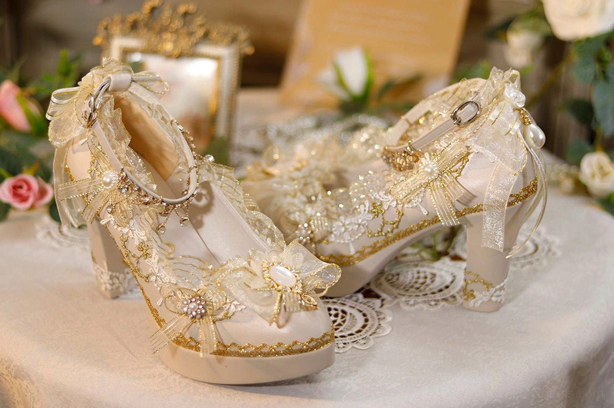 Low side angle view of handmade Lolita heels featuring platform block heel gem-centered front bow and sheer ruffled shoe opening trim