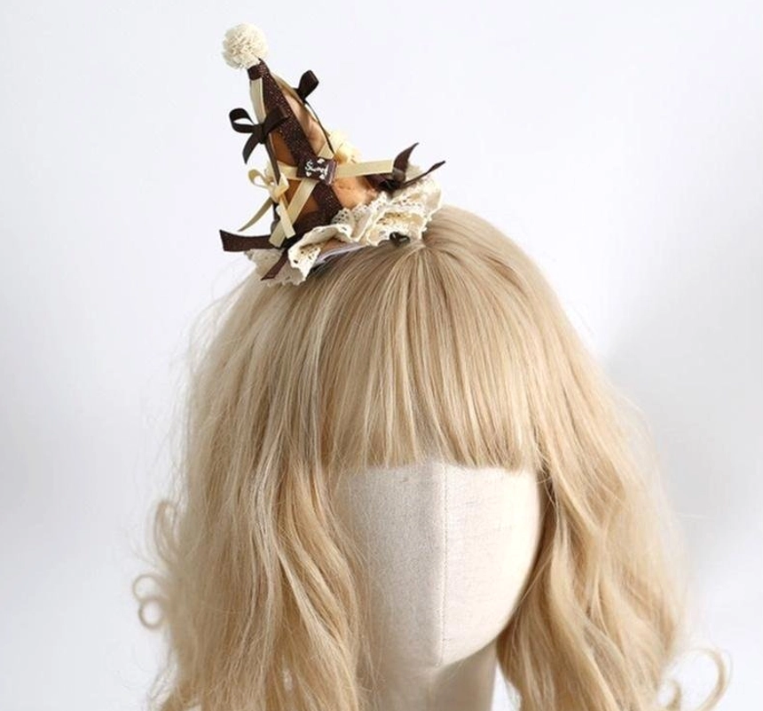 Lolita party hat hair accessory with pointed decorated hat ruffled lace small pom-pom on top and satin ribbon details shown on mannequin top-down side perspective view