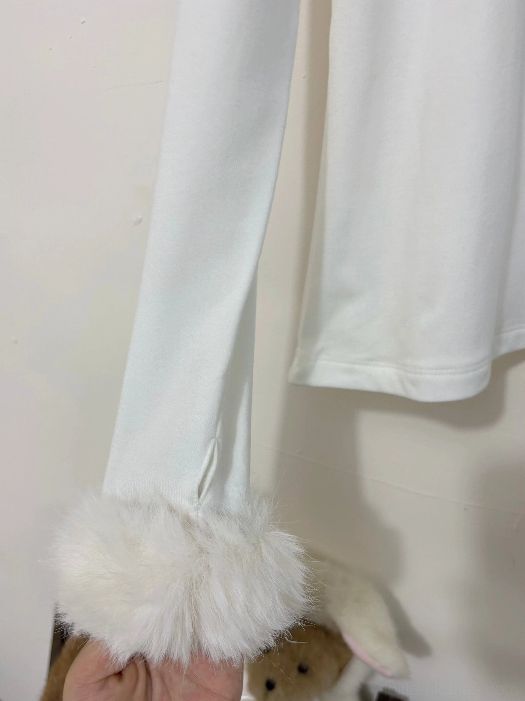 Close-up view of long sleeve and fuzzy fur cuff on white lolita inner wear showing slim sleeve design fluffy cuff decoration and stretchy soft knit fabric