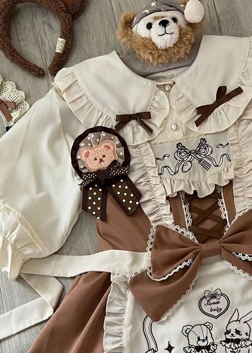 Close-up details of brown lolita maid JSK dress, ruffled peter pan collar, bear-themed brooch, decorative bows, vintage embroidery patterns