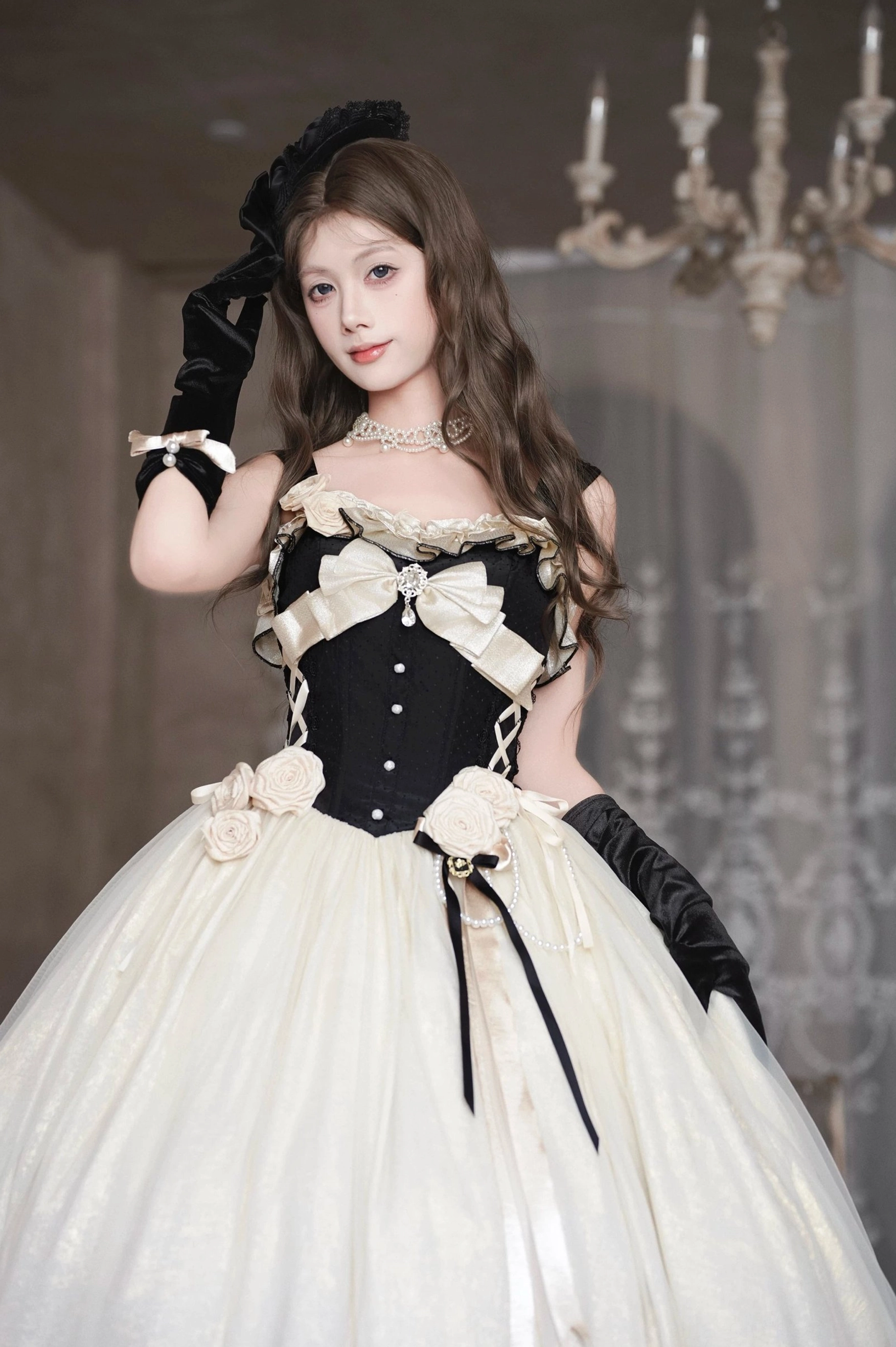 Close-up front full-body view of Classic Lolita JSK dress with model adjusting headpiece, pearl choker necklace, detailed corset stitching, front satin ribbon skirt ties accent