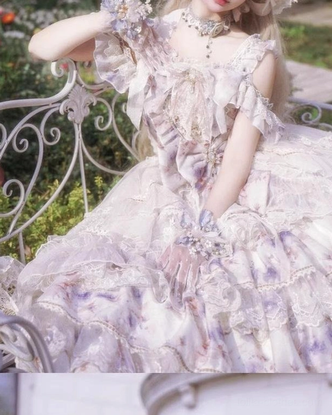 Close-up upper body detail shot of lolita dress showing ruffled off-shoulder collar, front decorative bow, criss-cross lace chest detailing, vintage necklace, matching lace gloves and soft chiffon fabric
