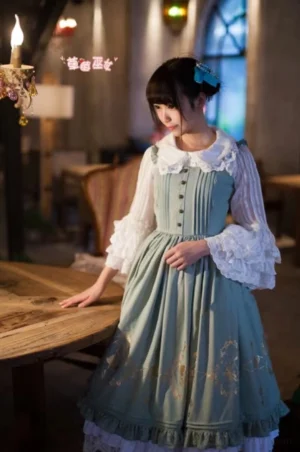 Mint green Lolita jumper skirt dress worn full-body at oblique angle, showing gold foil vintage patterns and ruffled trumpet sleeves, styled with white inner blouse in retro restaurant setting