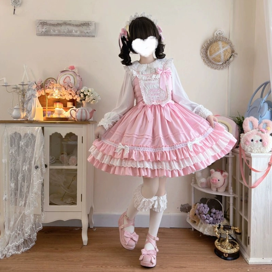 Pink sweet bear Lolita JSK dress side view front angle long sleeve white ruffled blouse underneath lifted leg showing white socks and loafers