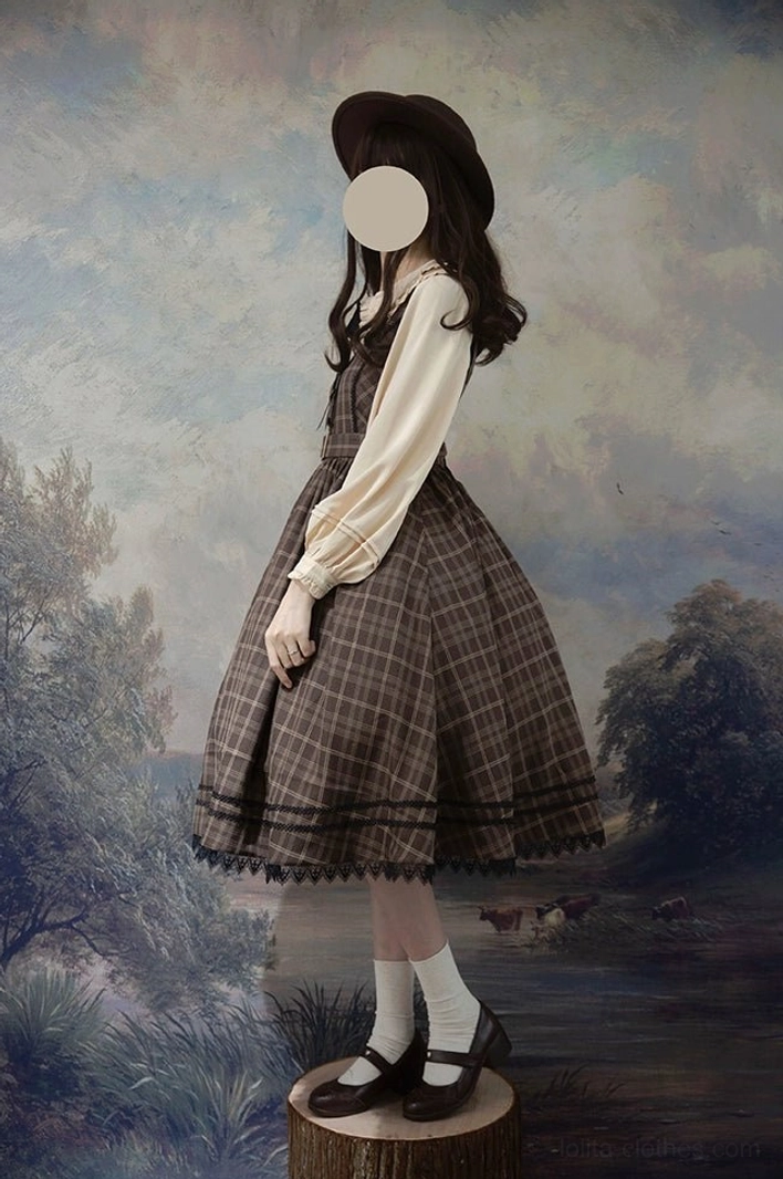 Full body side view of lolita jumper dress with matching lantern sleeve blouse tartan plaid a-line skirt lace hem on model wooden backdrop
