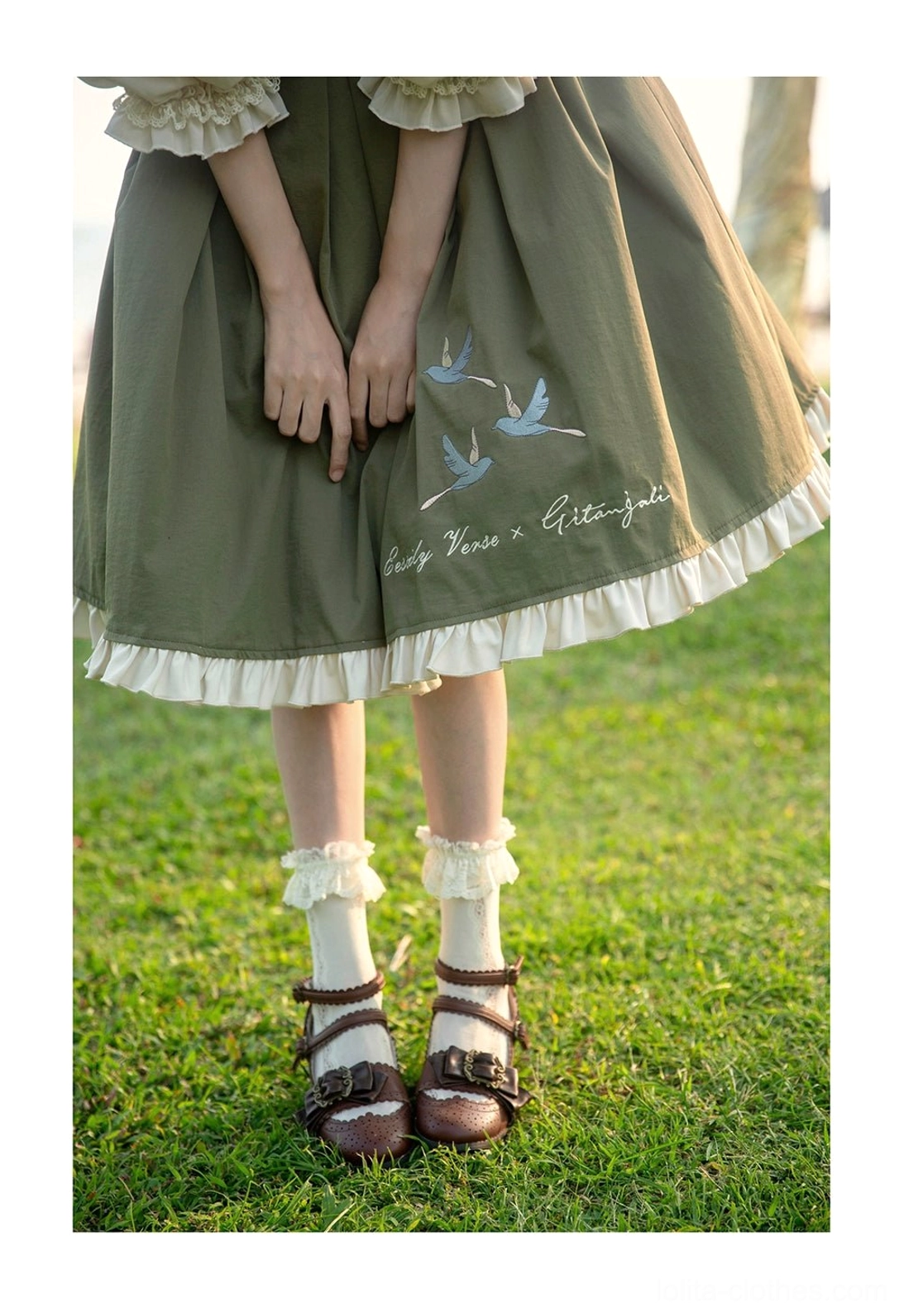 Lolita JSK dress ruffled hem design detail showing construction quality bird embroidery placement aesthetic