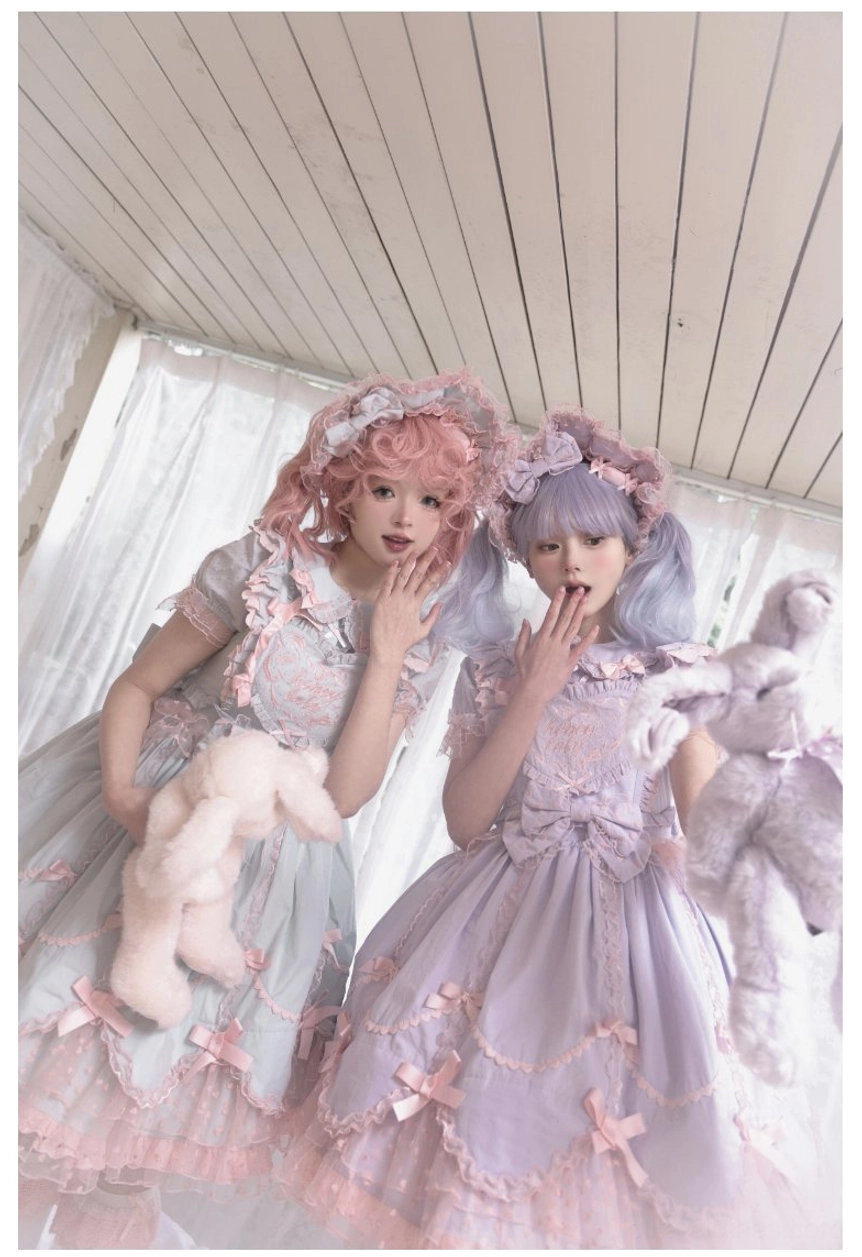 Two styles of sweet Lolita JSK dresses with matching accessories and plush toy props in bedroom setting