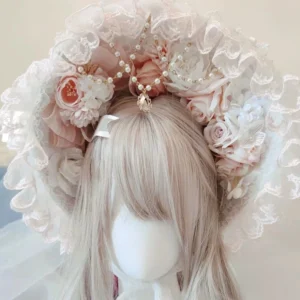 Elegant pink and white Lolita lace bonnet headdress with 1.2-meter veil, ruffled trim, artificial peach roses, and pearl gold gem ornaments displayed on mannequin with ash blonde wig, frontal overhead view
