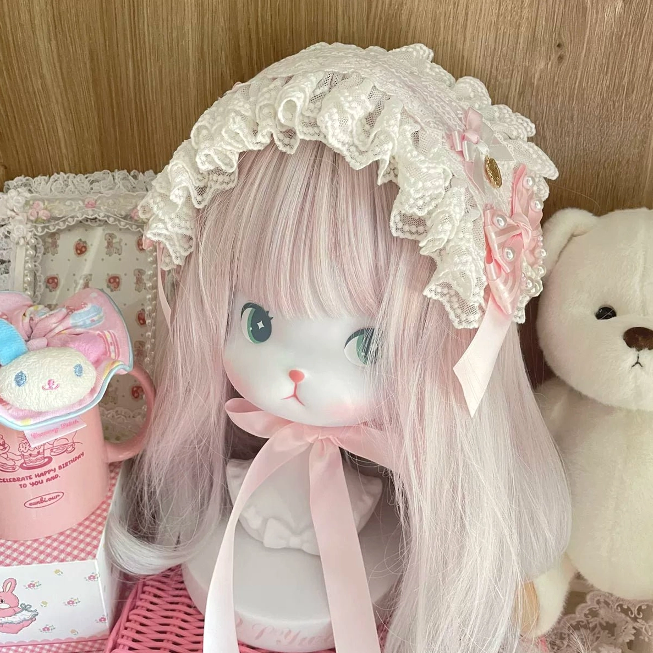 Lolita lace bonnet hairband direct front view, ruffled white lace trim, pink satin bow, soft pastel pink and white color scheme, cute alternative fashion accessory