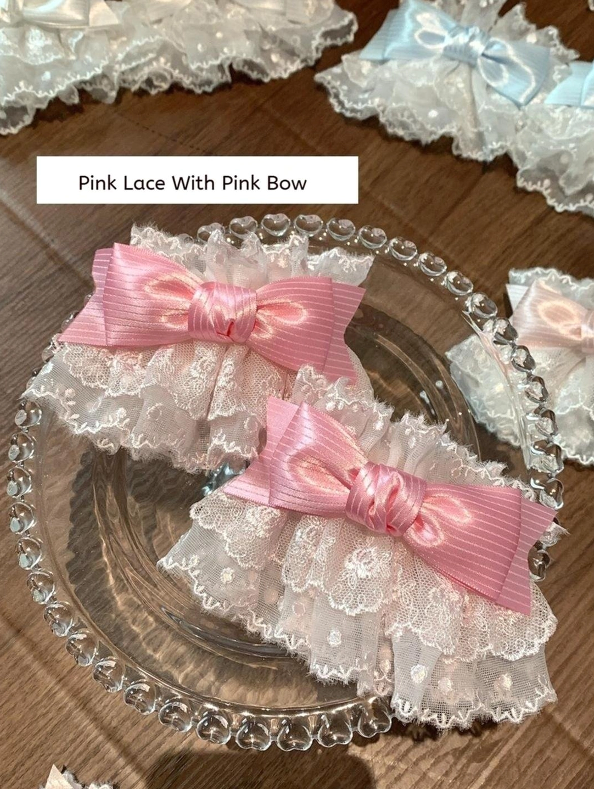 Pink satin bow Sweet Lolita wrist cuffs on elegant glass crystal decorative tray display