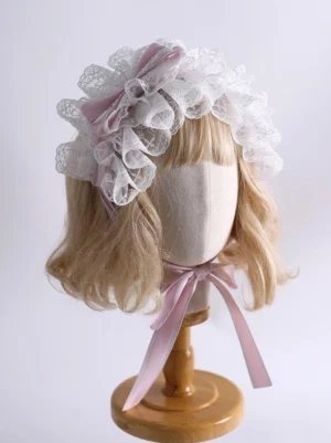 Delicate lolita lace hairband featuring light pink satin bows and graduated white ruffled lace tiers, styled on short blonde wig model