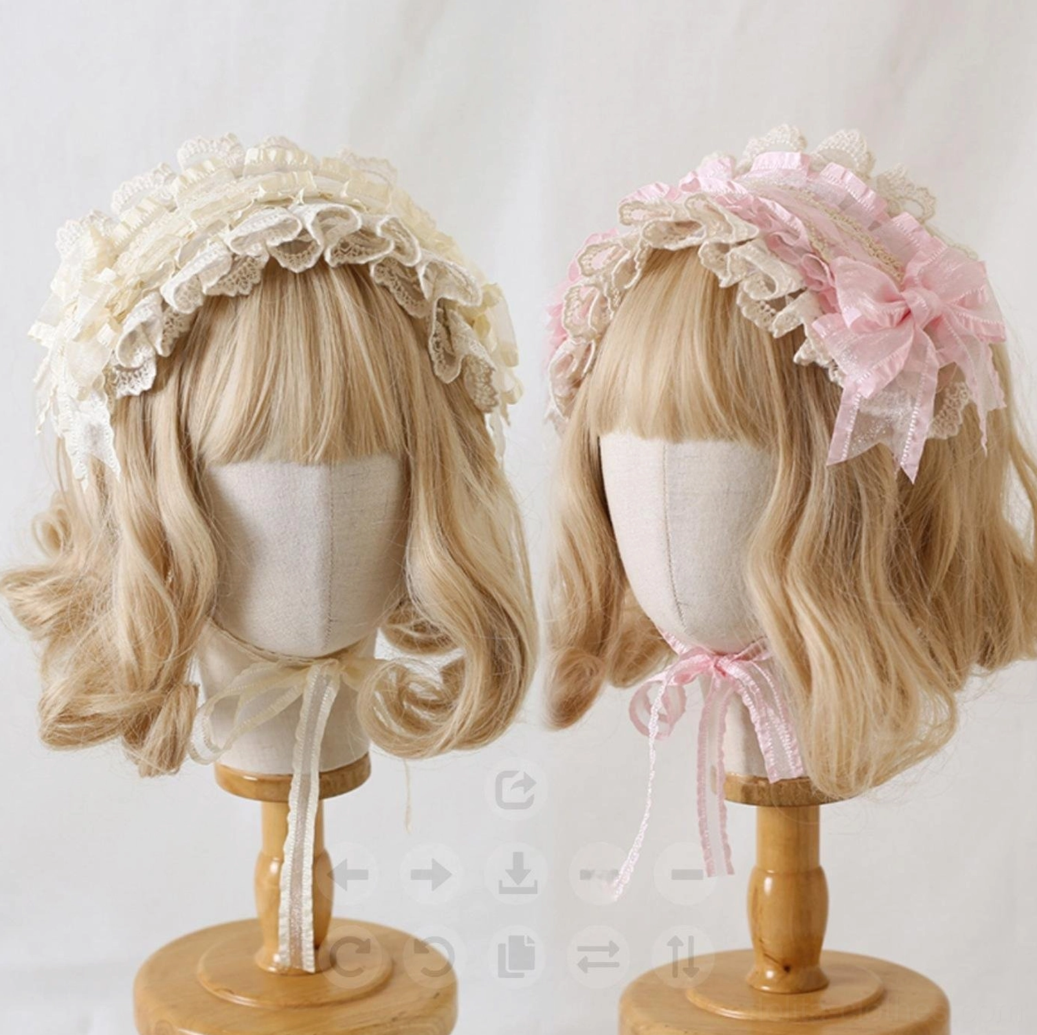 Beige and soft pink lolita lace hair clip headdress with ruffled lace trim and side mesh bow decoration, front view on wooden display stand