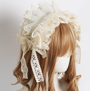 Lolita lace headdress accessory flat lay top-down view on white wooden base, cream white floral lace with metal spring clips attached and folded ruffled lace trim showing construction details