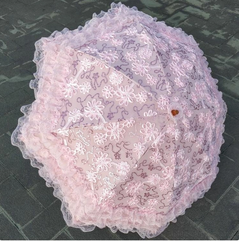 Foldable Lolita lace parasol in compact folded position showing portability and convenient storage for travel and outdoor Lolita events