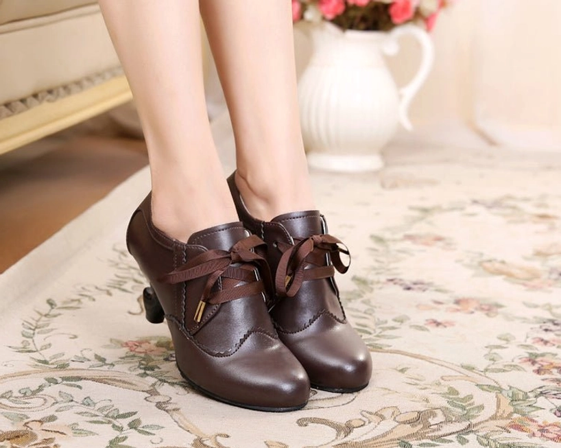 Lolita Mary Jane high heel shoes with delicate scalloped stitching, curved spool heel, and ribbon lace system representing quintessential Sweet Lolita footwear aesthetic