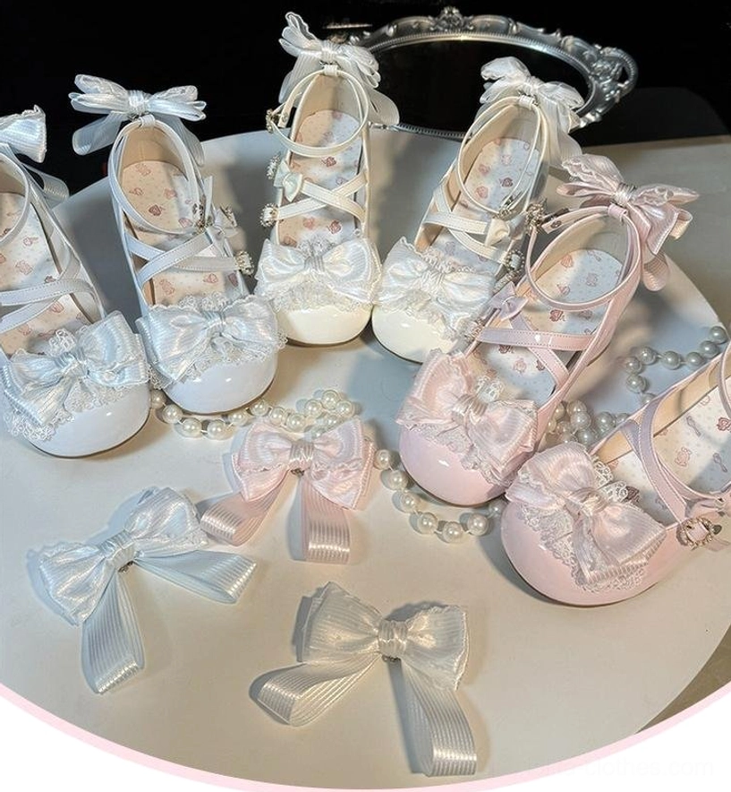 Collection of assorted Lolita Mary Jane shoes with interchangeable detachable heel bows displayed overhead with pearl ornaments showing round closed toe cross strap design multiple colorways