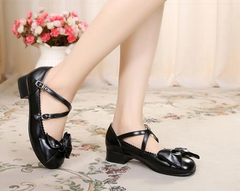 Dark blue lolita bow cross-strap shoes front detail view showing adjustable buckle closure