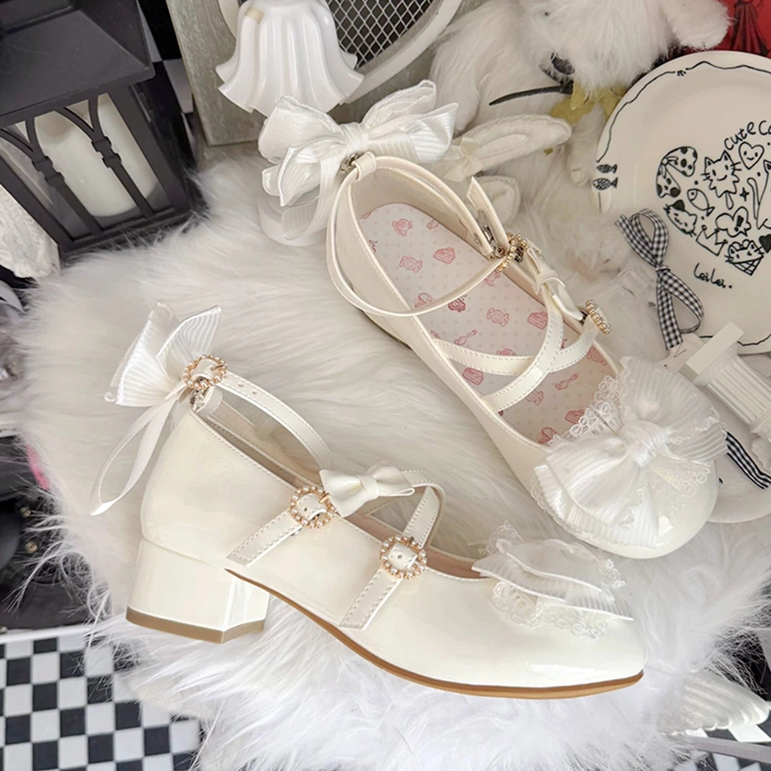 Off-white glossy Lolita Mary Jane shoes with matching accessories plush props decorated with heart-patterned insole cross straps ruffled lace trim detachable back bow overhead view
