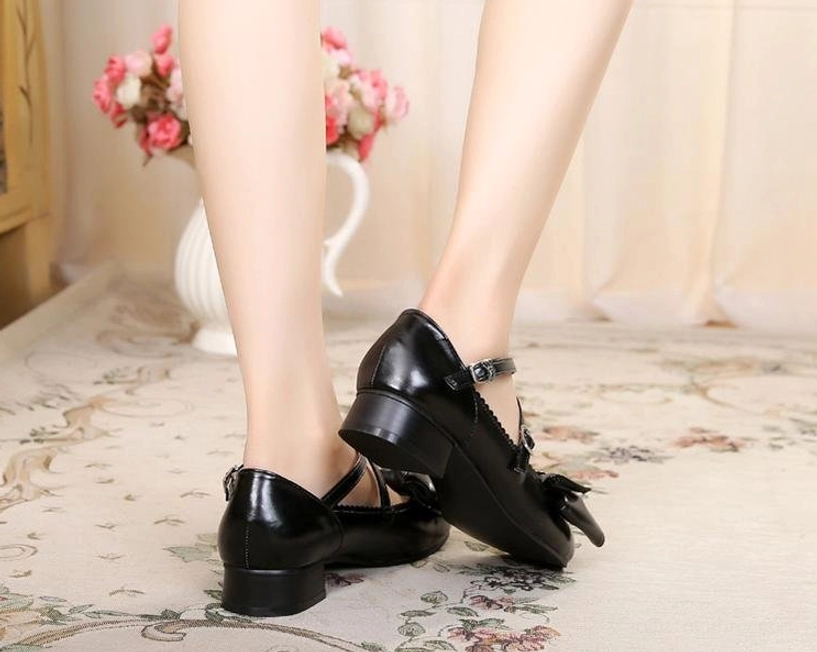 White lolita bow cross-strap shoes close-up detail of bow decoration and ankle straps