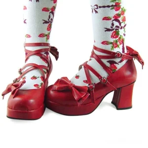 Wine red glossy Lolita Mary Jane shoes with dual crisscross straps, heart-shaped buckles, and heel bow decoration paired with strawberry print socks