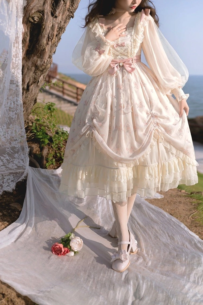Lolita OP dress side back three-quarter view showcasing sheer long sleeves, draped front skirt details, prominent pink waist bow, layered ruffled hem creating voluminous silhouette